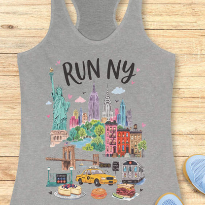 grey racerback running tank top featuring a colorful illustrated “RUN NY” design. The artwork showcases iconic New York City landmarks and symbols, including the Statue of Liberty, the Empire State Building, the Chrysler Building, the Brooklyn Bridge, brownstone row houses, a subway train, and a subway entrance. Additional New York elements include a yellow taxi cab, a race clock, a pedestrian crossing sign that reads “DON'T WALK RUN,” Central Park-inspired greenery, cheesecake, a bagel sandwich, and a pas