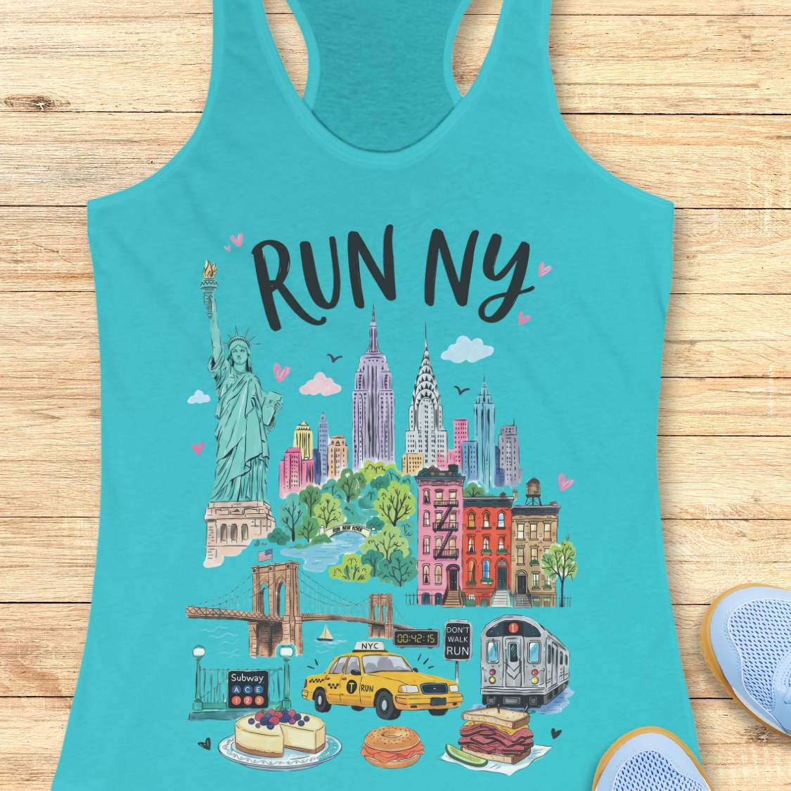 blue  racerback running tank top featuring a colorful illustrated “RUN NY” design. The artwork showcases iconic New York City landmarks and symbols, including the Statue of Liberty, the Empire State Building, the Chrysler Building, the Brooklyn Bridge, brownstone row houses, a subway train, and a subway entrance. Additional New York elements include a yellow taxi cab, a race clock, a pedestrian crossing sign that reads “DON'T WALK RUN,” Central Park-inspired greenery, cheesecake, a bagel sandwich, and a pas