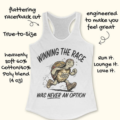 White racerback running tank top displayed on a light wood background, featuring a vintage-style illustration of a turtle running in sneakers and wearing a race bib numbered “002.” The design includes the humorous slogan: “WINNING THE RACE WAS NEVER AN OPTION.” Partial blue running shoes are visible in the bottom corners of the image.