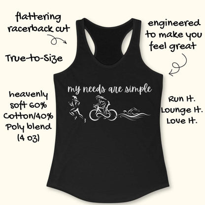 black racerback tank top displayed on a light wood background, featuring a minimalist triathlon-themed design. The graphic includes the phrase “my needs are simple” in black script lettering above line-art illustrations of a runner, cyclist, and swimmer, representing the three disciplines of triathlon. Partial blue running shoes are visible in the bottom corners of the image.