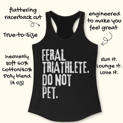 Black racerback tank top displayed on a light wood background, featuring bold distressed white lettering that reads: “FERAL TRIATHLETE. DO NOT PET.” The minimalist design uses large vintage-style typography for a humorous triathlon-themed statement. Partial blue running shoes are visible in the bottom corners of the image.