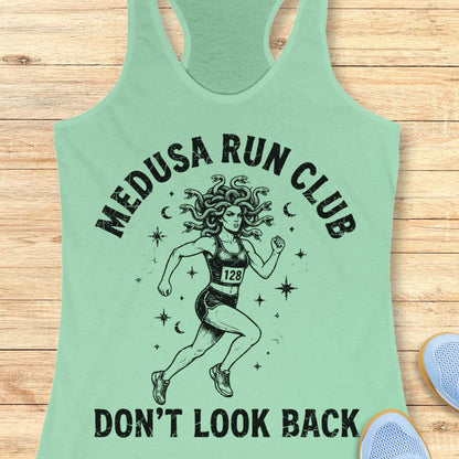 mint women's running tank top featuring a Medusa runner with snake hair, race bib 128, stars, and moons. Text reads "MEDUSA RUN CLUB" and "DON'T LOOK BACK." Mythology-inspired running apparel for women runners, featuring an empowering Greek mythology fitness design.