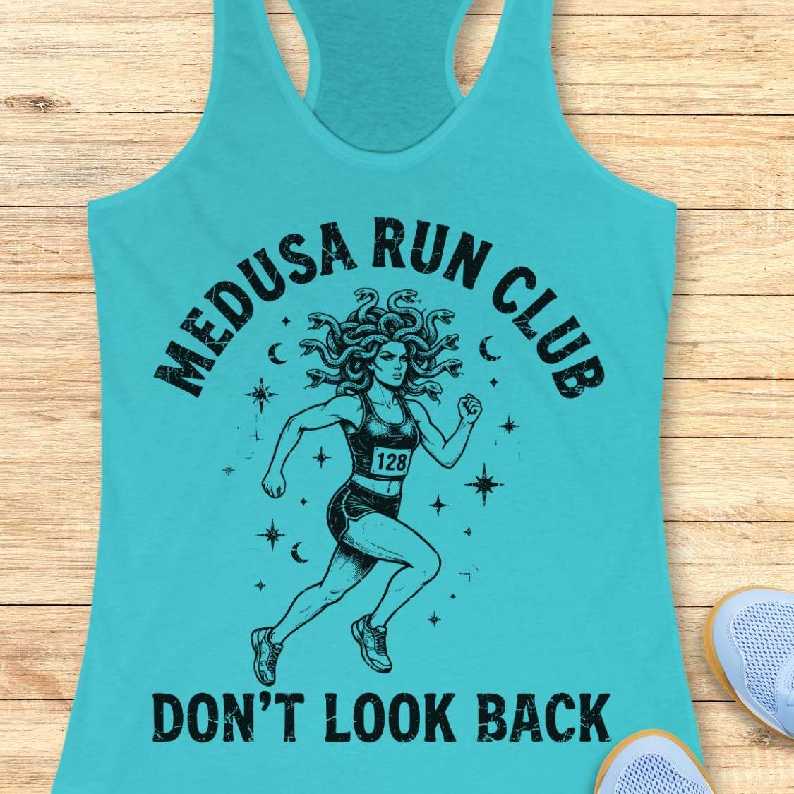 blue women's running tank top featuring a Medusa runner with snake hair, race bib 128, stars, and moons. Text reads "MEDUSA RUN CLUB" and "DON'T LOOK BACK." Mythology-inspired running apparel for women runners, featuring an empowering Greek mythology fitness design.