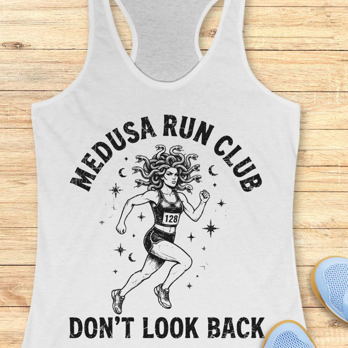 white women's running tank top featuring a Medusa runner with snake hair, race bib 128, stars, and moons. Text reads "MEDUSA RUN CLUB" and "DON'T LOOK BACK." Mythology-inspired running apparel for women runners, featuring an empowering Greek mythology fitness design.