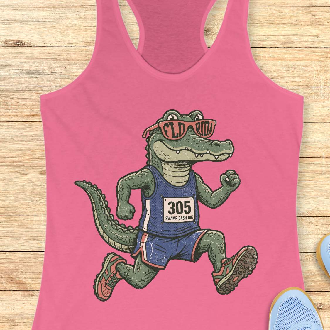 Funny Florida runner pink tank top featuring a cartoon alligator wearing running gear, race bib 305, and Florida sunglasses while running. Perfect apparel for Florida runners, women runners, marathon training, trail runners, swamp runners, and anyone who loves running in the heat and humidity.