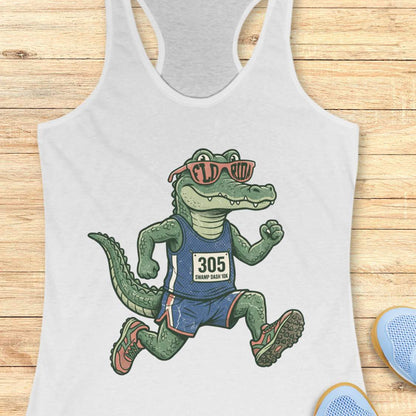 Funny Florida runner white tank top featuring a cartoon alligator wearing running gear, race bib 305, and Florida sunglasses while running. Perfect apparel for Florida runners, women runners, marathon training, trail runners, swamp runners, and anyone who loves running in the heat and humidity.