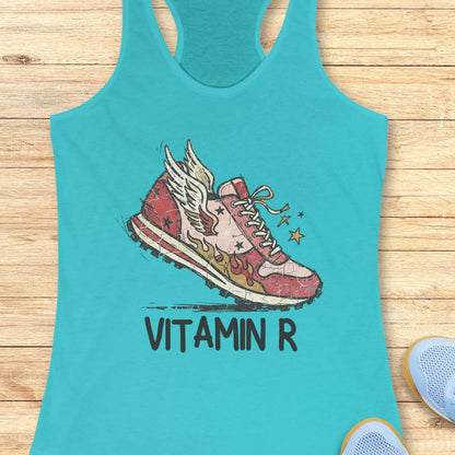 Funny women’s running blue tank top featuring a vintage winged running shoe with flames and the slogan “Vitamin R.” A playful design for runners, marathon runners, half marathon runners, trail runners, and women who consider running their favorite form of therapy and energy.