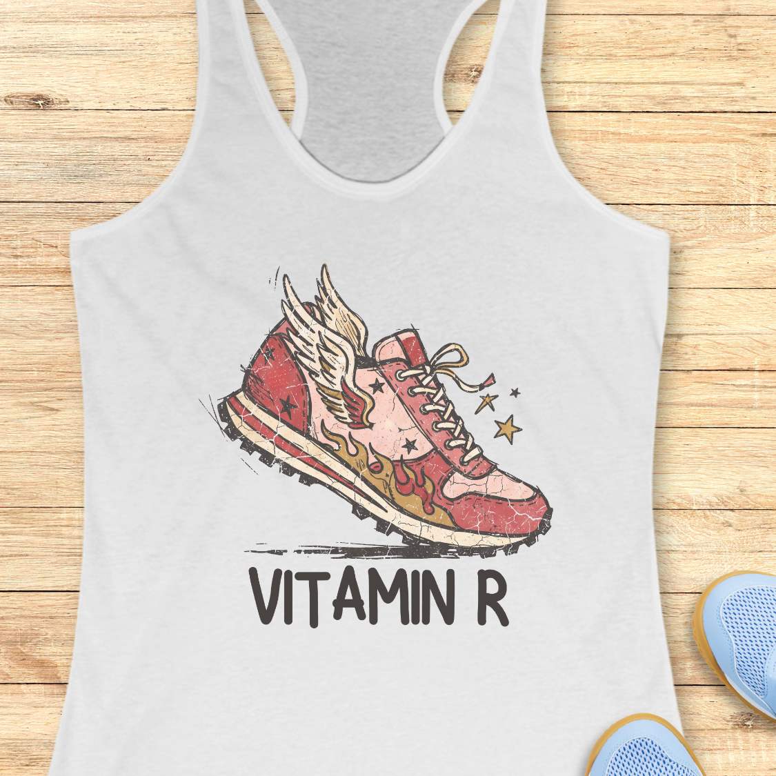 Funny women’s running white tank top featuring a vintage winged running shoe with flames and the slogan “Vitamin R.” A playful design for runners, marathon runners, half marathon runners, trail runners, and women who consider running their favorite form of therapy and energy.