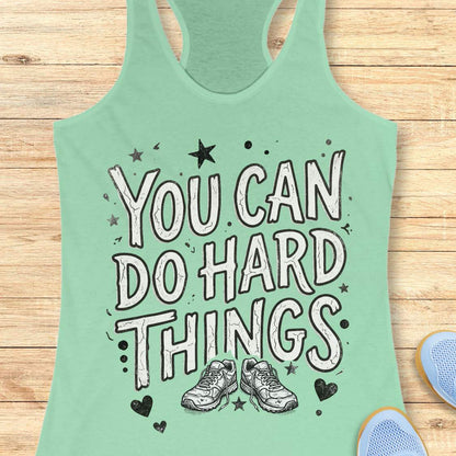 Motivational running mint racebak tank top featuring the quote “You Can Do Hard Things” with running shoes, stars, and hearts on a black women's racerback tank, inspirational gift for runners, marathon runners, and fitness lovers.
