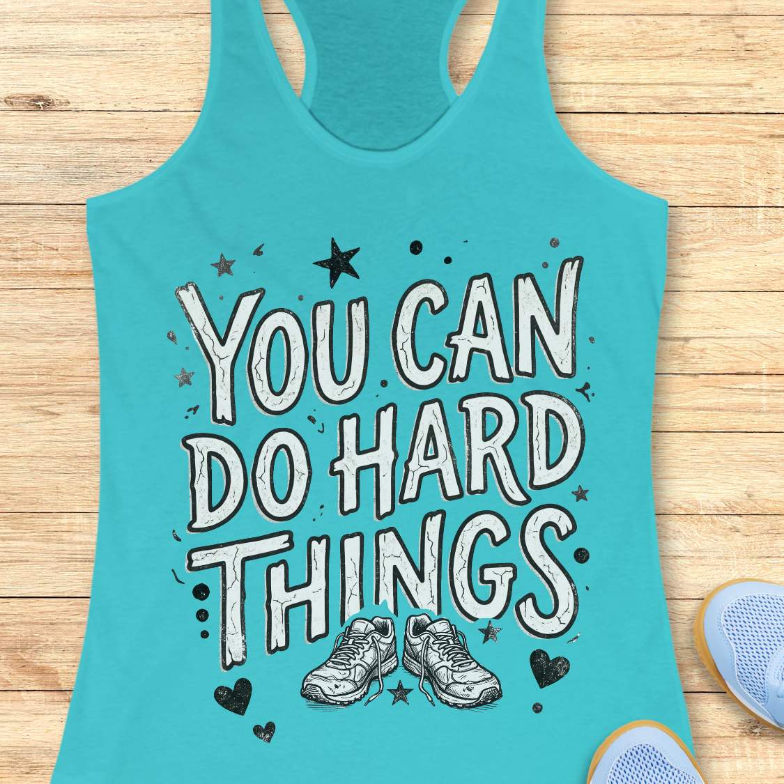 Motivational running blue racebak tank top featuring the quote “You Can Do Hard Things” with running shoes, stars, and hearts on a black women's racerback tank, inspirational gift for runners, marathon runners, and fitness lovers.