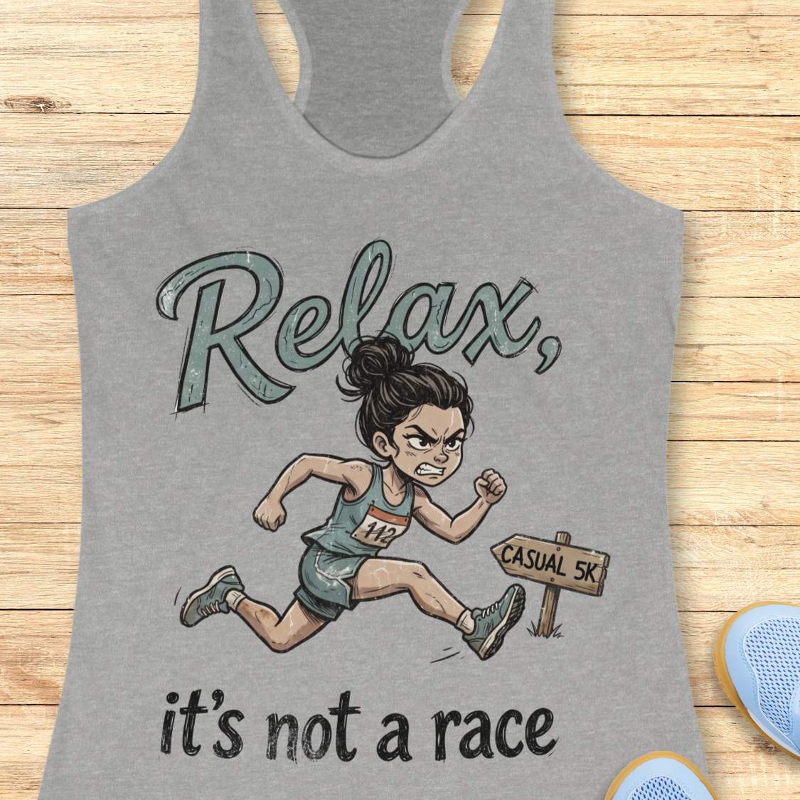 Funny women's running grey tank top featuring a cartoon runner sprinting intensely during a casual 5K race with the phrase "Relax, it's not a race." The design shows a determined runner wearing a race bib charging past a sign labeled "Casual 5K," creating a humorous contrast between a relaxed fun run and competitive running behavior. Perfect for women runners, race enthusiasts, 5K participants, running club members, and anyone who takes recreational races a little too seriously. 
