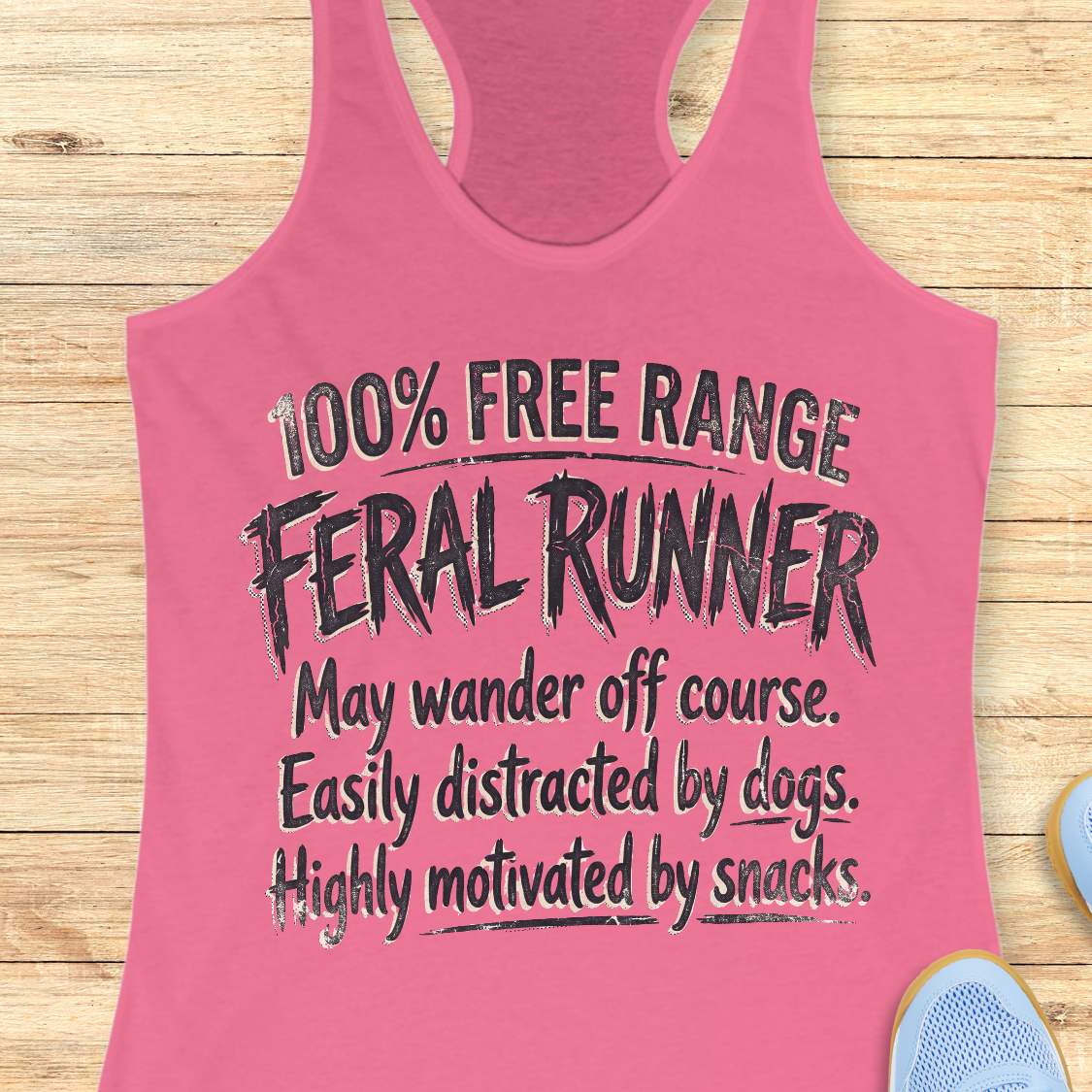 Funny women's running pink tank top featuring the phrase "100% FREE RANGE FERAL RUNNER" in bold distressed typography, followed by the humorous traits "May wander off course. Easily distracted by dogs. Highly motivated by snacks." This playful running design celebrates runners who embrace adventure, love dogs, enjoy trail running, and are always thinking about their next snack. Perfect for women runners, dog-loving runners, trail runners, marathon runners, half marathon runners, 5K participants,