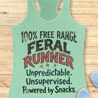 Funny women's running tank top featuring the bold phrase "100% FREE RANGE FERAL RUNNER" with the humorous personality traits "Unpredictable. Unsupervised. Powered by Snacks." displayed in distressed vintage-style typography on a mint racerback tank. This playful running design celebrates free-spirited runners who embrace adventure, independence, and a love of post-run treats. Perfect for women runners, trail runners, marathon runners, half marathon participants, 5K runners, running club members, and 
