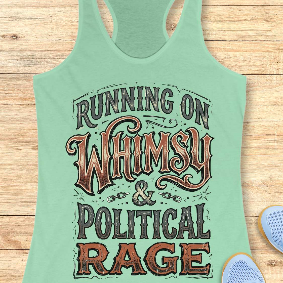 women's mint racerback running tank top featuring the whimsical slogan "Running On Whimsy & Political Rage" in ornate vintage-inspired typography. Humorous running apparel for women who embrace both lighthearted fun and passionate determination. Unique statement tank for female runners, marathon runners, trail runners, and fitness enthusiasts who combine a love of running, humor, and strong convictions. Displayed on a wooden background with running shoes, highlighting a bold and artistic design perfect for