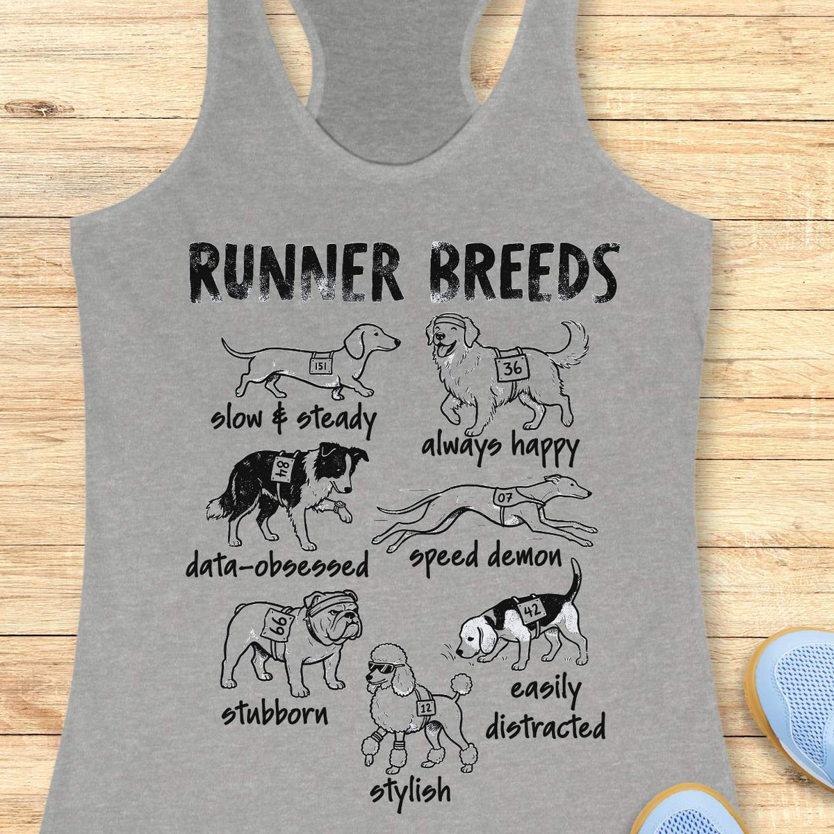 Funny Runner Breeds grey tank top featuring dog breed runner personalities including Slow & Steady Dachshund, Always Happy Golden Retriever, Data-Obsessed Border Collie, Speed Demon Greyhound, Stubborn Bulldog, Easily Distracted Beagle, and Stylish Poodle. Humorous running apparel for women runners, marathon runners, half marathon participants, dog lovers, race enthusiasts, and fitness fans. Graphic running tank with race bib dogs and runner humor illustration.