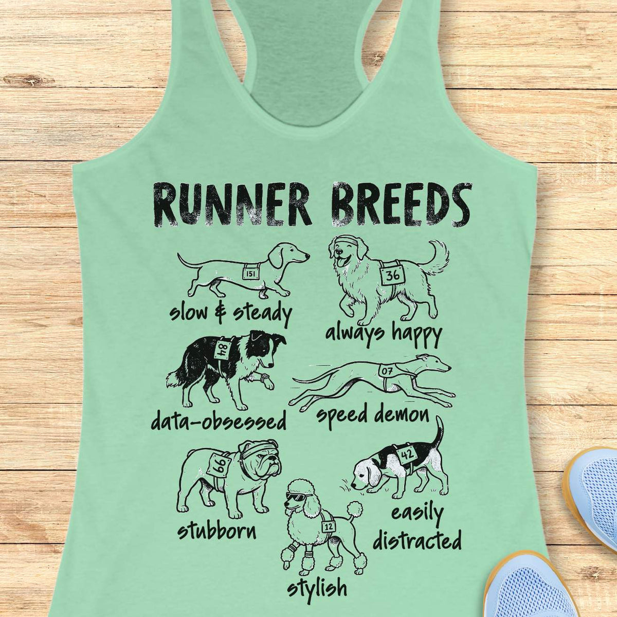 Funny Runner Breeds mint tank top featuring dog breed runner personalities including Slow & Steady Dachshund, Always Happy Golden Retriever, Data-Obsessed Border Collie, Speed Demon Greyhound, Stubborn Bulldog, Easily Distracted Beagle, and Stylish Poodle. Humorous running apparel for women runners, marathon runners, half marathon participants, dog lovers, race enthusiasts, and fitness fans. Graphic running tank with race bib dogs and runner humor illustration.