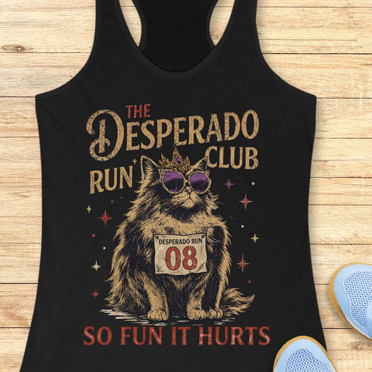 Women's black racerback tank top with humorous running-themed cat graphic. The design features a regal fluffy cat wearing a jeweled crown and purple sunglasses, displaying a race bib marked 'Desperado Run 08.' Vintage distressed typography reads 'The Desperado Run Club' above and 'So Fun It Hurts' below. A playful gift for cat moms, runners, joggers, marathon enthusiasts, trail runners, and women who love funny running apparel with unique race day and run club themes