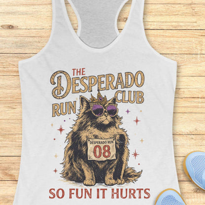 Women's white racerback tank top with humorous running-themed cat graphic. The design features a regal fluffy cat wearing a jeweled crown and purple sunglasses, displaying a race bib marked 'Desperado Run 08.' Vintage distressed typography reads 'The Desperado Run Club' above and 'So Fun It Hurts' below. A playful gift for cat moms, runners, joggers, marathon enthusiasts, trail runners, and women who love funny running apparel with unique race day and run club themes