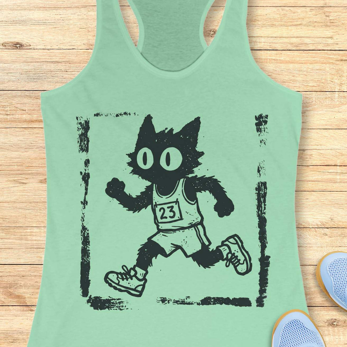 Women's mint racerback tank top with a retro distressed running cat graphic. The design showcases a quirky black cartoon cat with oversized eyes sprinting in running gear, including a race bib marked 23, shorts, and sneakers. Rendered in a vintage hand-drawn illustration style with grunge screen-print textures and a weathered border, the artwork blends running culture with cat lover humor. Ideal apparel for women who enjoy running, marathon training, race day events, jogging, trail running, fitness, and fun