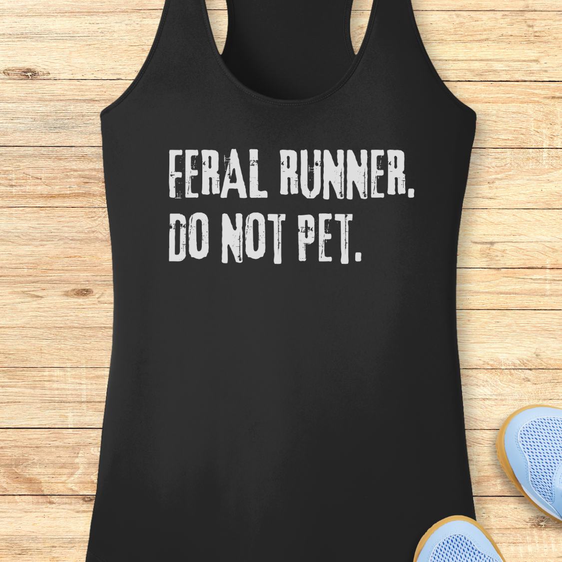 A black racerback performance tank top with the distressed white text 'FERAL RUNNER. DO NOT PET.