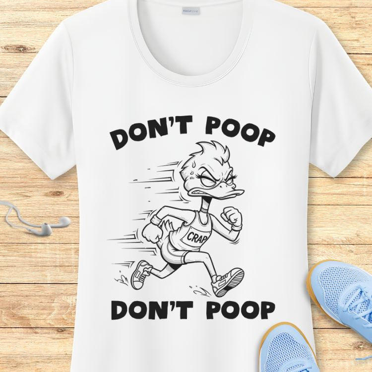 Graphic design on a white t-shirt featuring a black and white cartoon running duck character, sweating with a determined expression and wearing a singlet labeled "CRAP," with "DON'T POOP" text above and below the duck, displayed on a light wooden background with light blue running shoes and white earbuds
