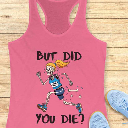 Graphic design on a pink racerback tank top depicting a humorous skeleton runner with a blonde ponytail, blue sports bra with SOS, and blue shorts, actively losing leg bones while running, above the black text BUT DID YOU DIE, laid flat on a light wooden surface with light blue athletic shoes visible