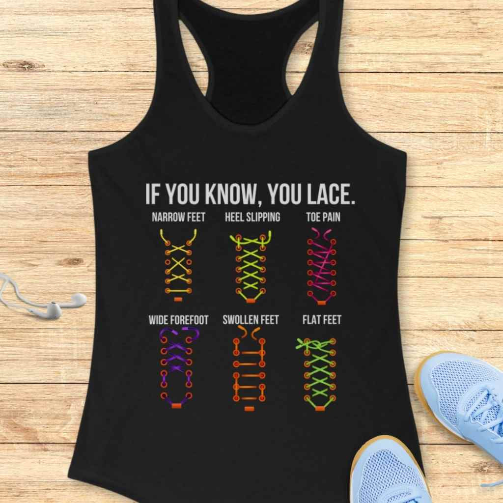 Graphic print on a black tank top with text 'IF YOU KNOW, YOU LACE' illustrating six distinct, colorful shoelace patterns like yellow for narrow feet and pink for toe pain all displayed on a wooden surface next to blue running shoes