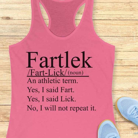 Pink racerback tank top displaying the humorous definition Fartlek as 'Fart-Lick' an athletic term with additional text 'Yes, I said Fart. Yes, I said Lick. No, I will not repeat it' against a wooden background beside light blue athletic shoes