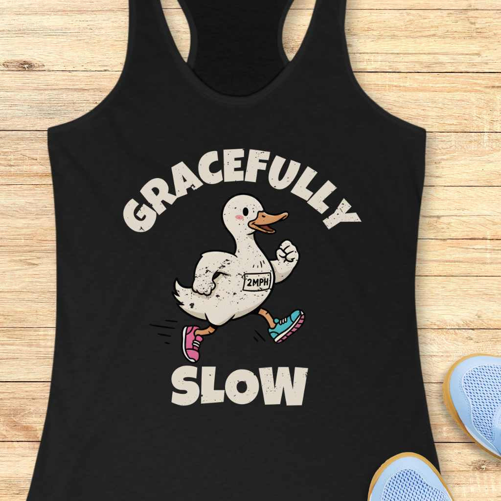 Black tank top with a graphic of a duck running and text 'Gracefully Slow' on a wooden surface.