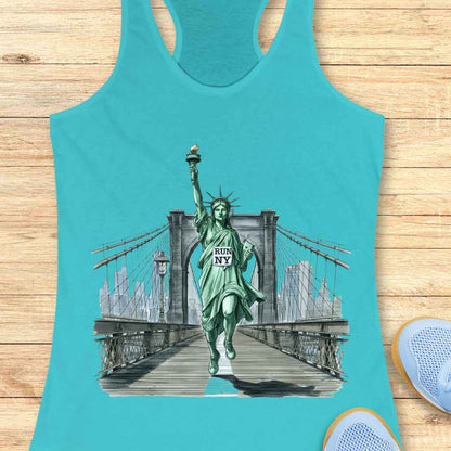 Graphic design on a vibrant teal tank top depicting the Statue of Liberty running on the Brooklyn Bridge, holding a white sign that reads RUN NY, with the New York City skyline in the background