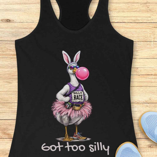 Graphic design on a black t-shirt depicting a silly goose character adorned with bunny ears and sunglasses, blowing a vibrant pink bubble gum bubble while wearing a purple SILLY RACE tank top, a fluffy pink tutu, a fanny pack, and colorful sneakers, with the phrase got too silly printed beneath