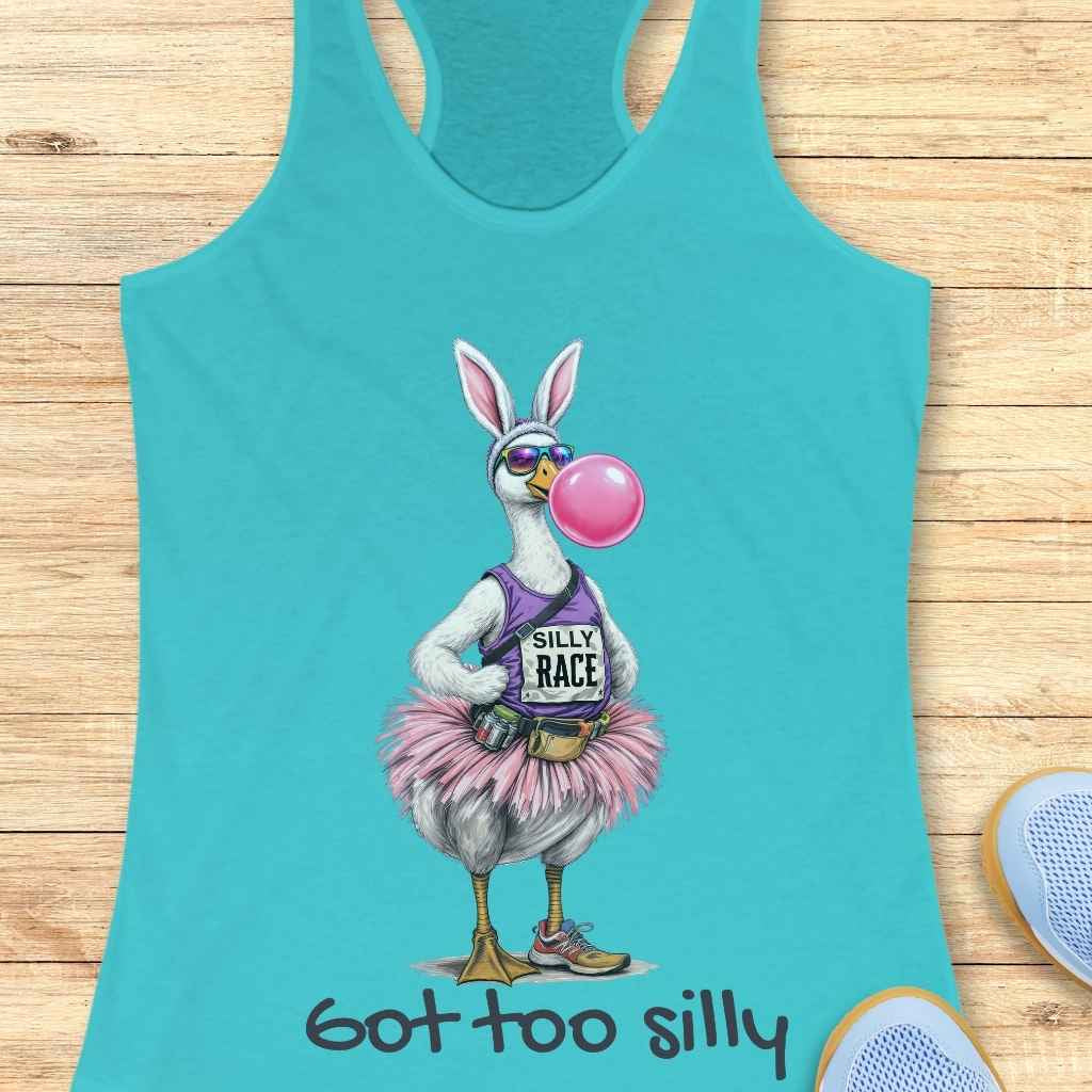 Graphic design on a teal tank top featuring a whimsical goose wearing white bunny ears, reflective sunglasses, blowing a pink bubblegum bubble, dressed in a purple "Silly Race" tank top, a fluffy pink tutu, running shoes, with "Got too silly" written beneath