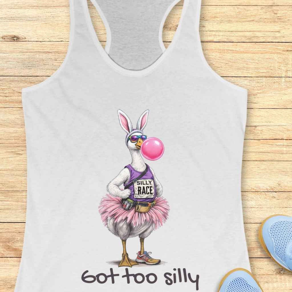 Digital illustration of a quirky goose wearing bunny ears, mirrored sunglasses, blowing a large pink bubble gum bubble, a purple 'Silly Race' tank top, fluffy pink tutu, fanny pack, and orange-accented running shoes, appearing on a white tank top above the phrase 'got too silly'