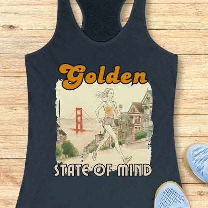 Illustrated design on a dark blue tank top features a woman running through San Francisco with the iconic reddish-orange Golden Gate Bridge, pastel Painted Ladies Victorian houses, and the text Golden STATE OF MIND in vibrant orange and white