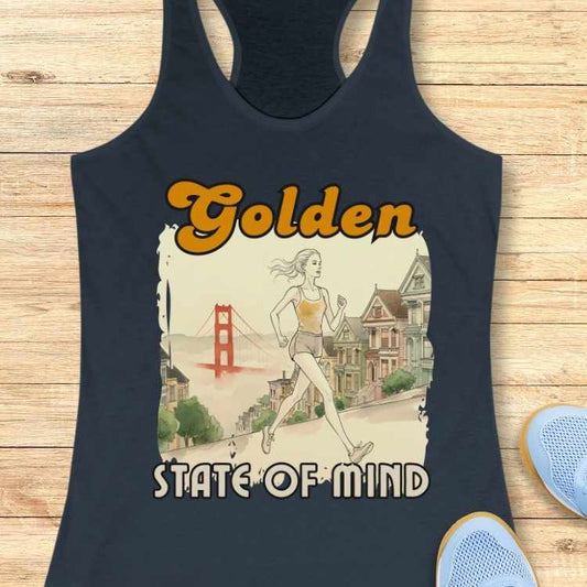 Illustrated design on a dark blue tank top features a woman running through San Francisco with the iconic reddish-orange Golden Gate Bridge, pastel Painted Ladies Victorian houses, and the text Golden STATE OF MIND in vibrant orange and white