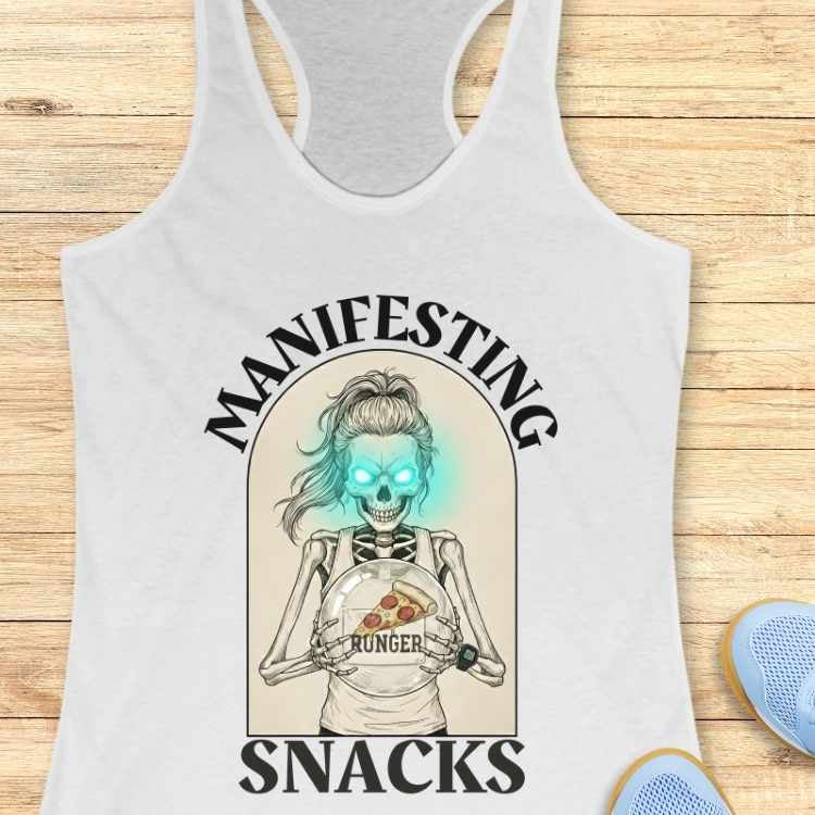 white tank top with skeleton design and text 'Manifesting Hunger Snacks' on a wooden surface.