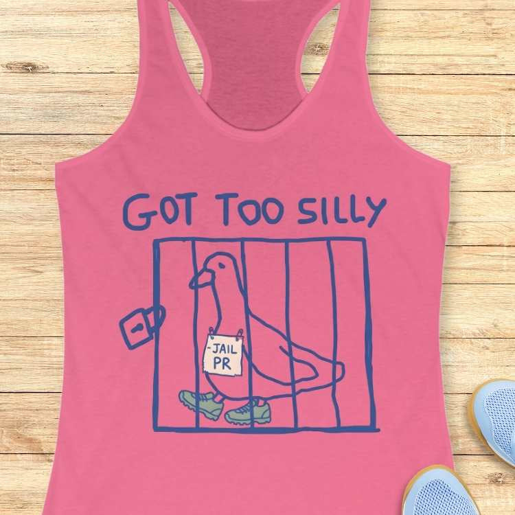 Pink racerback tank top depicting a blue line art drawing of a pigeon in a cage wearing green sneakers and holding a JAIL PR sign, with the phrase GOT TOO SILLY printed above, all against a light wooden plank background