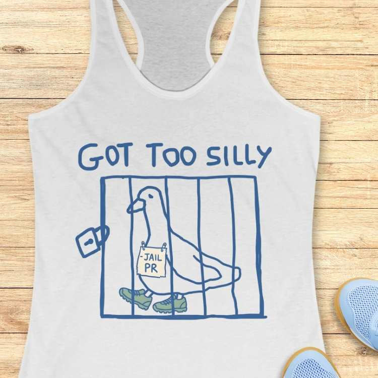 White tank top graphic featuring blue text GOT TOO SILLY above a blue line-art cage containing a white cartoon pigeon wearing green sneakers and holding a JAIL PR sign