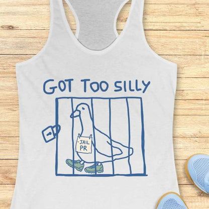 White tank top graphic featuring blue text GOT TOO SILLY above a blue line-art cage containing a white cartoon pigeon wearing green sneakers and holding a JAIL PR sign