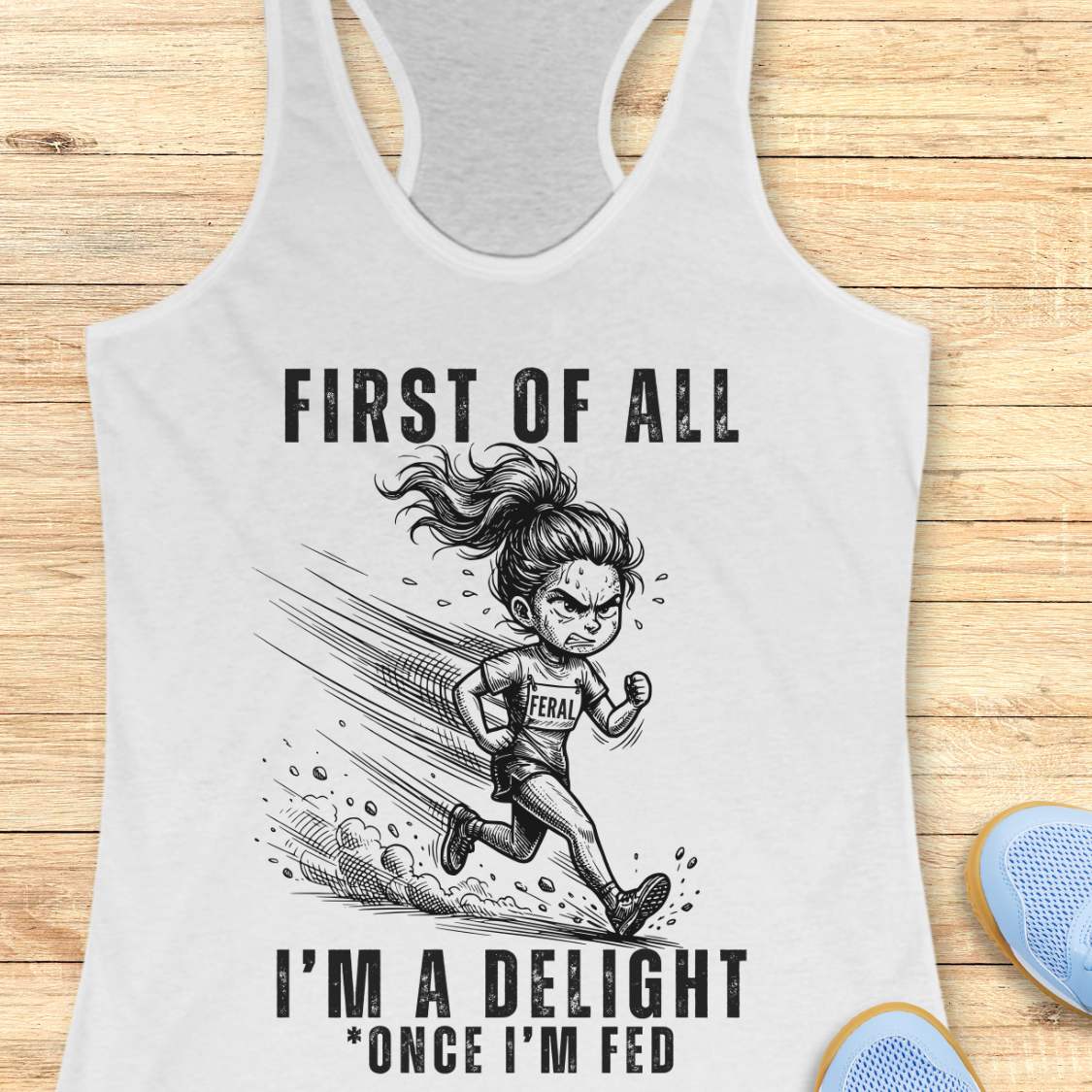 white tank top with graphic design and text first  of all I'm a delight , once I'm fed, on a wooden surface