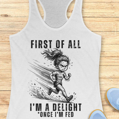 white tank top with graphic design and text first  of all I'm a delight , once I'm fed, on a wooden surface