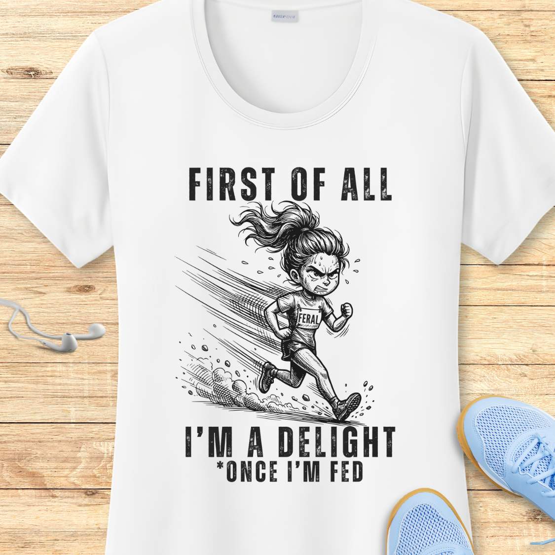white performance tee with a graphic of a running girl and text first  of all I'm a delight , once I'm fed, on a wooden surface