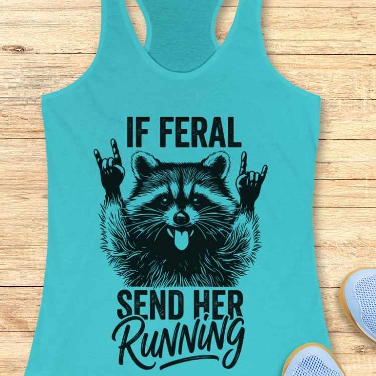 Turquoise tank top with a raccoon graphic and text on a wooden surface