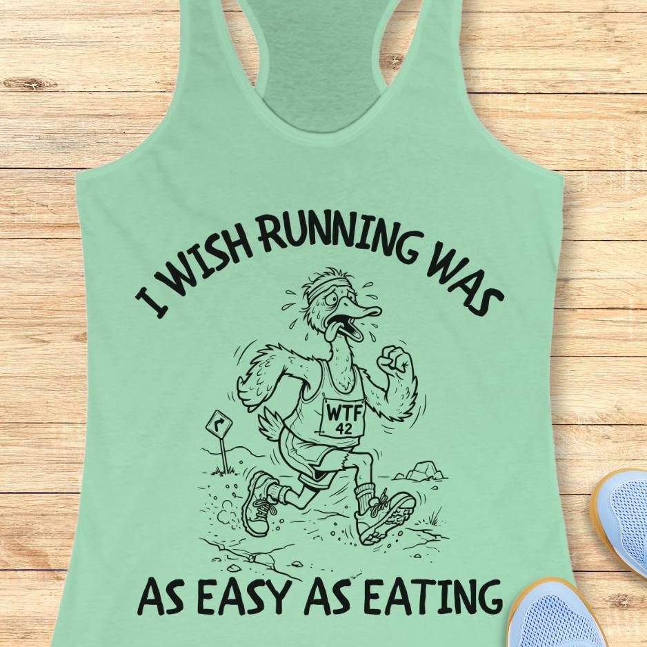 Light green tank top with a graphic and text on a wooden surface