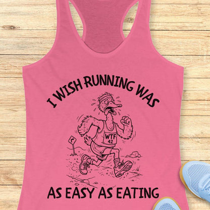 Pink tank top with humorous running graphic and text on a wooden surface