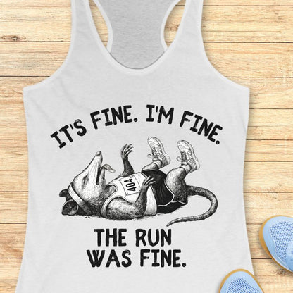 Gray tank top with humorous graphic and text on a wooden surface