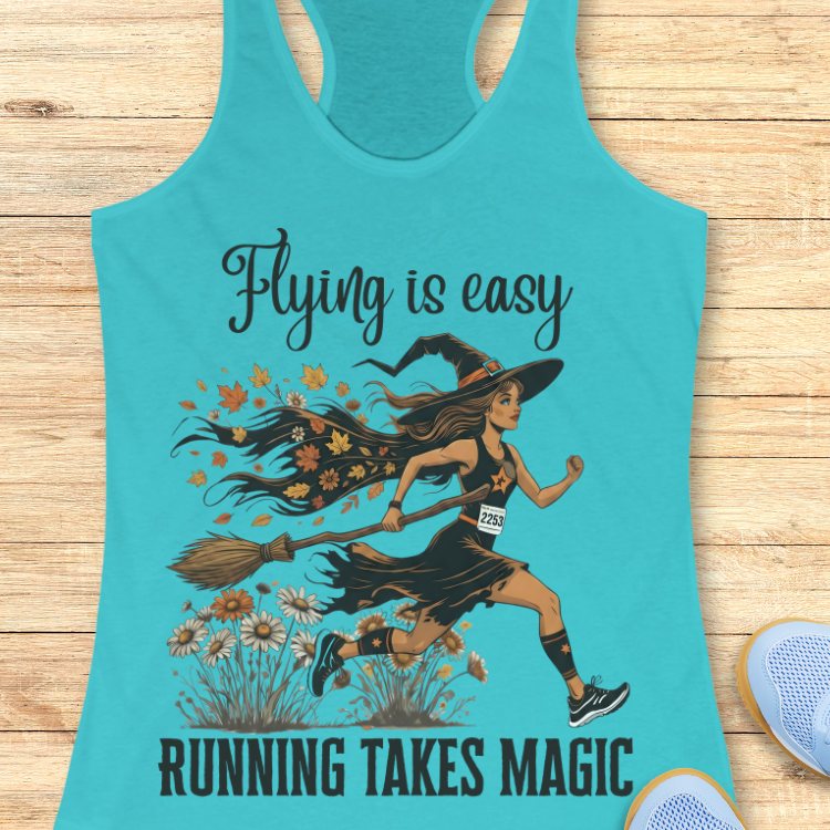 Turquoise tank top with a witch graphic and text 'Flying is easy, running takes magic' on a wooden surface