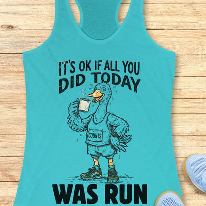 Tahiti blue tank top with a graphic of a duck and text "it's ok if all you did today was run" on a wooden surface