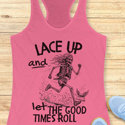 Pink tank top with skeleton graphic and text 'Lace up and let the good times roll' on a wooden surface.