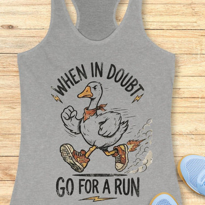 Gray tank top with a graphic of a duck and text 'When in doubt, go for a run' on a wooden surface.